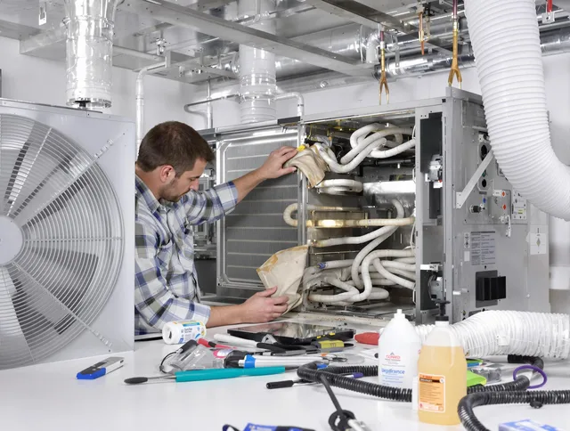 Holliston Air Duct Cleaning specialist performing precision AC coil cleaning in Holliston
