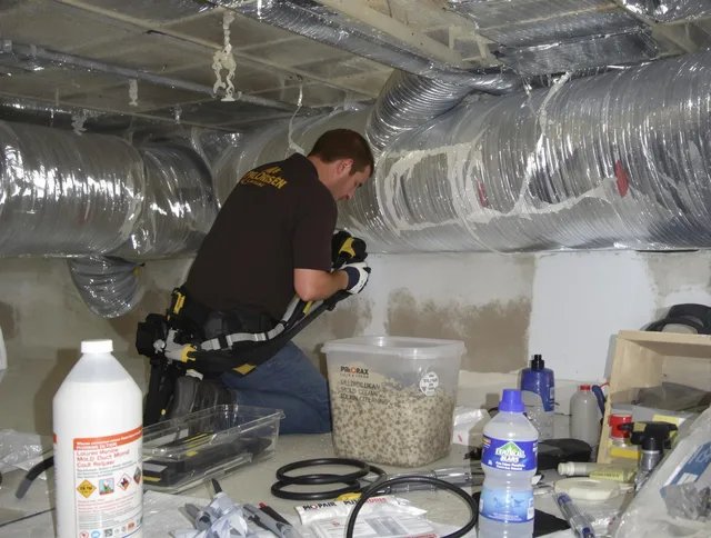 Holliston Air Duct Cleaning specialist performing professional mold removal from air ducts in Holliston