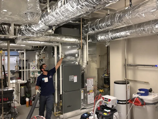 Holliston Air Duct Cleaning specialist performing thorough furnace duct cleaning in a Holliston residence