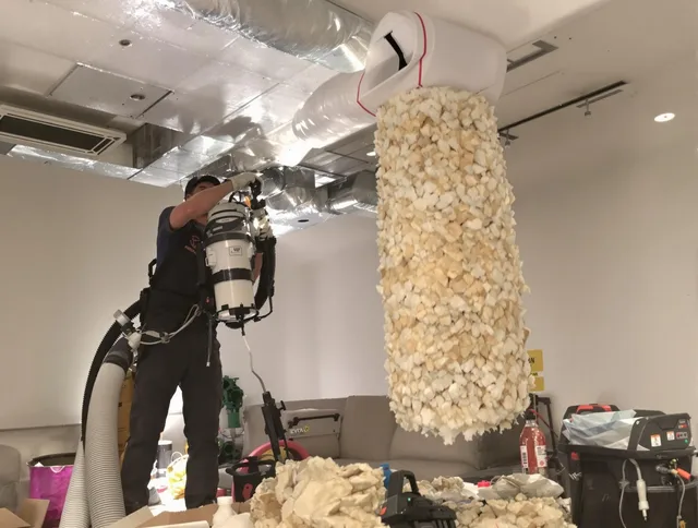 Holliston Air Duct Cleaning technician performing precision vacuum insulation removal in a residential property in Holliston