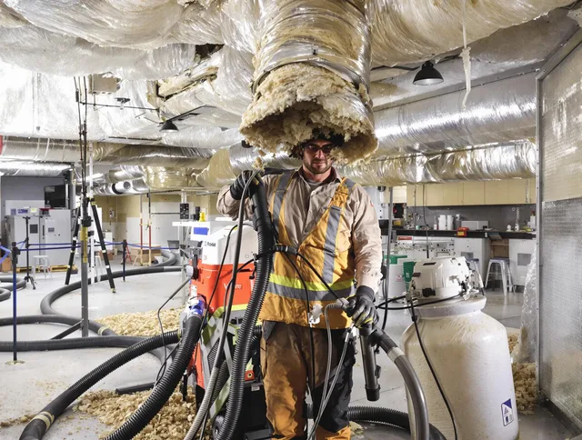Professional vacuum insulation removal by Holliston Air Duct Cleaning expert in Holliston